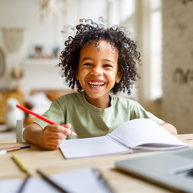 smiling boy doing homework