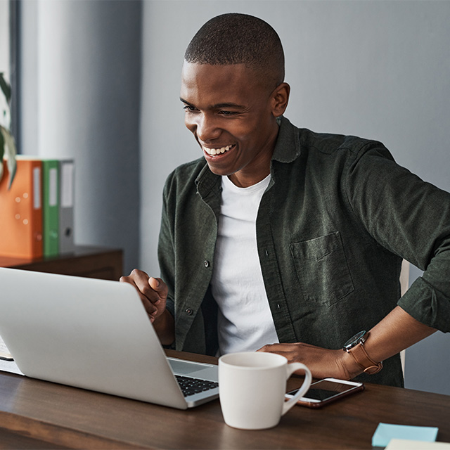 smiling man working on laptop
