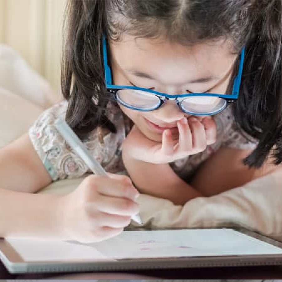 girl wearing glasses wit ha teblet